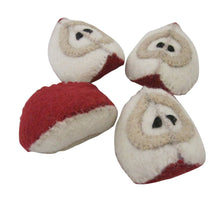 4 felted apple slices on a white background