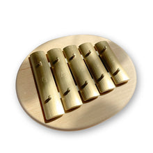 Round glockenspiel with notes g-e on a white background