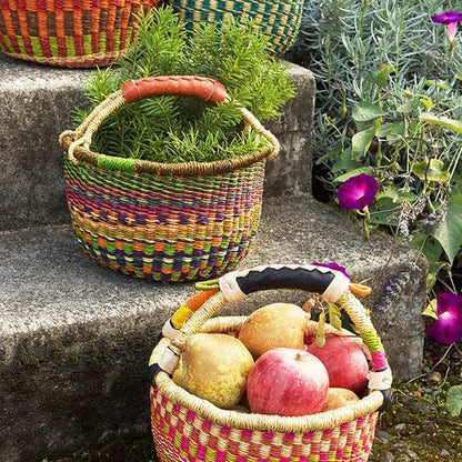Colorful woven baskets with fruits and plants on stone steps