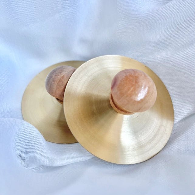 Set of two petite cymbals on a white background