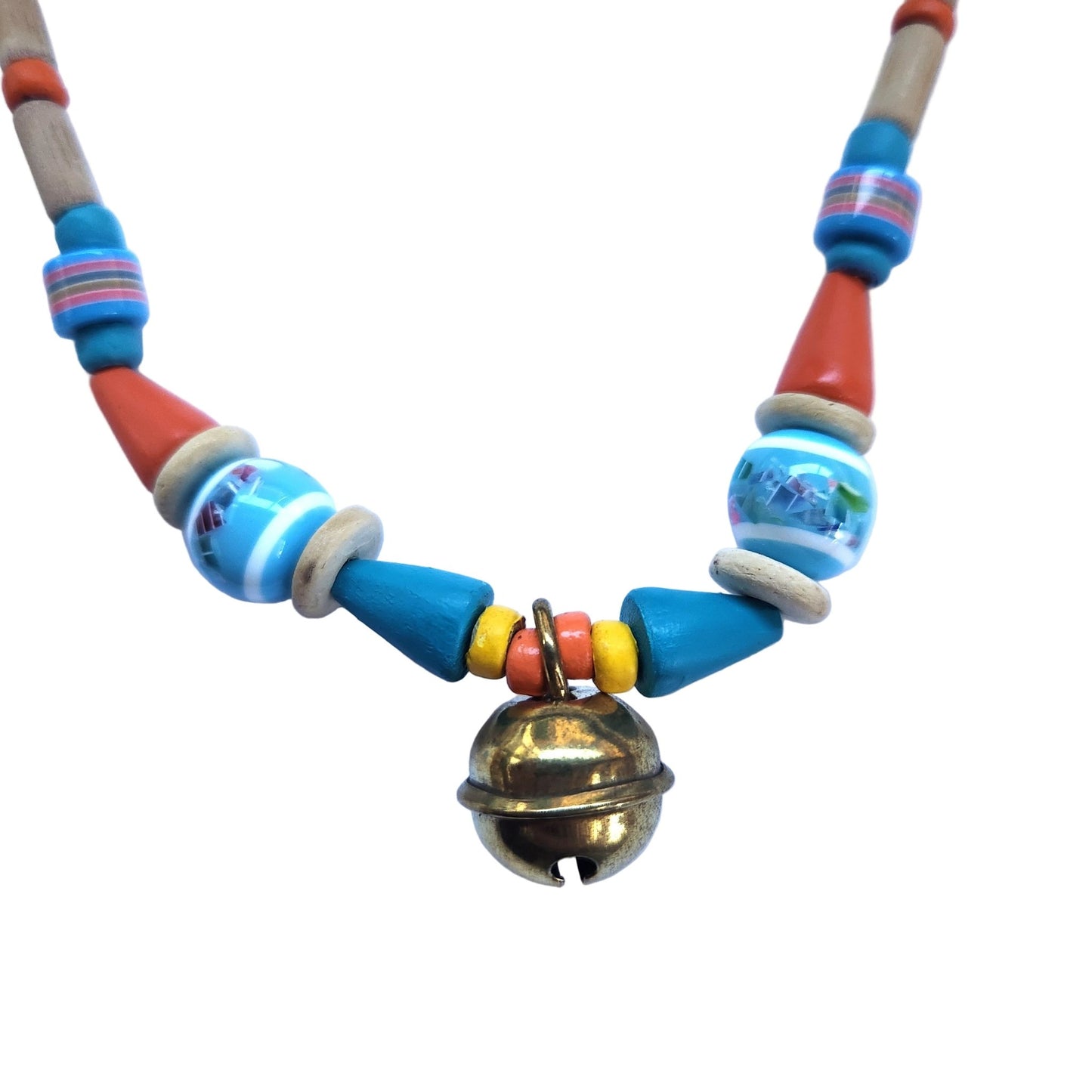 Close up of a colorful beaded necklace with a gold bell on a white background
