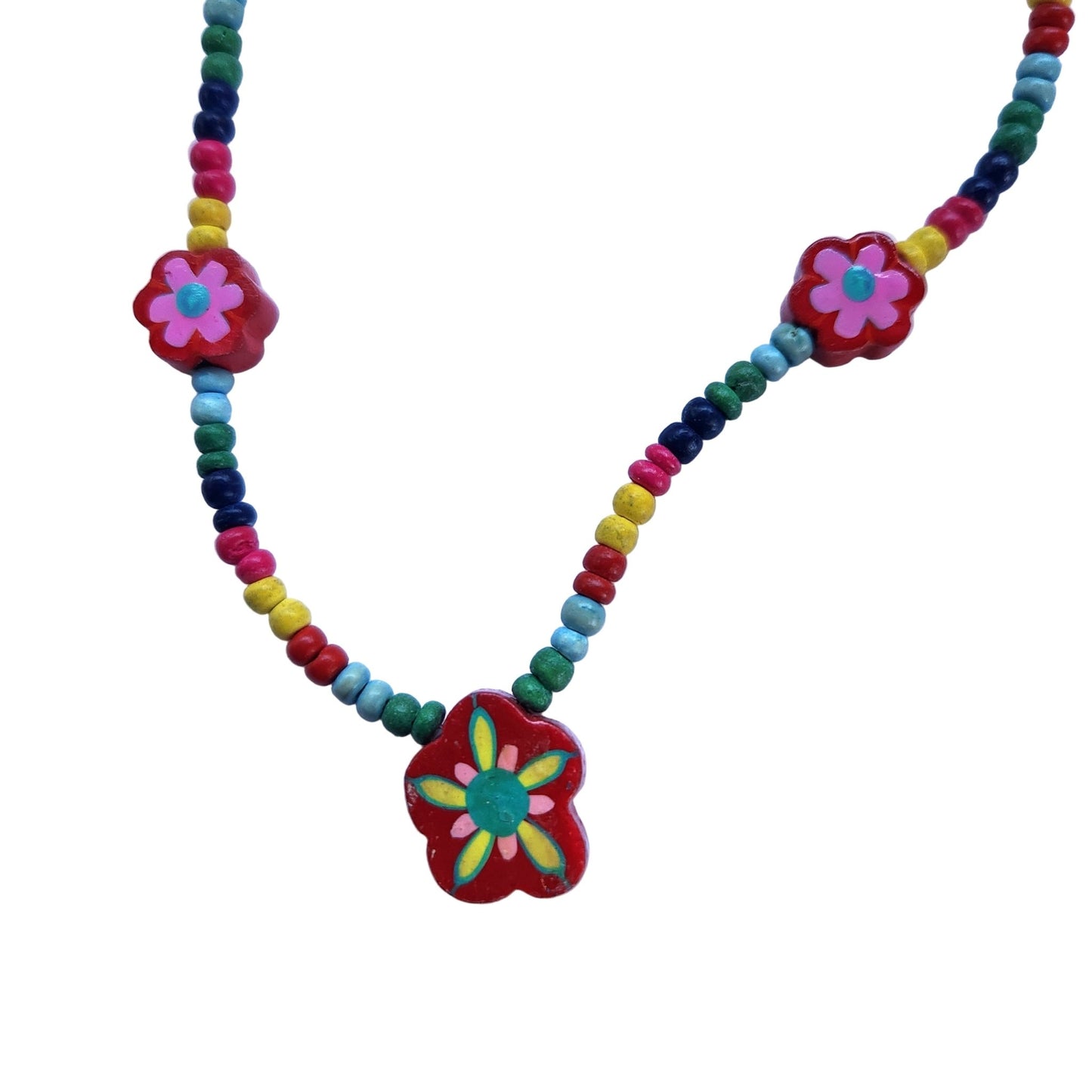 Close up of colorful beaded necklace with a flower pendant on a white background