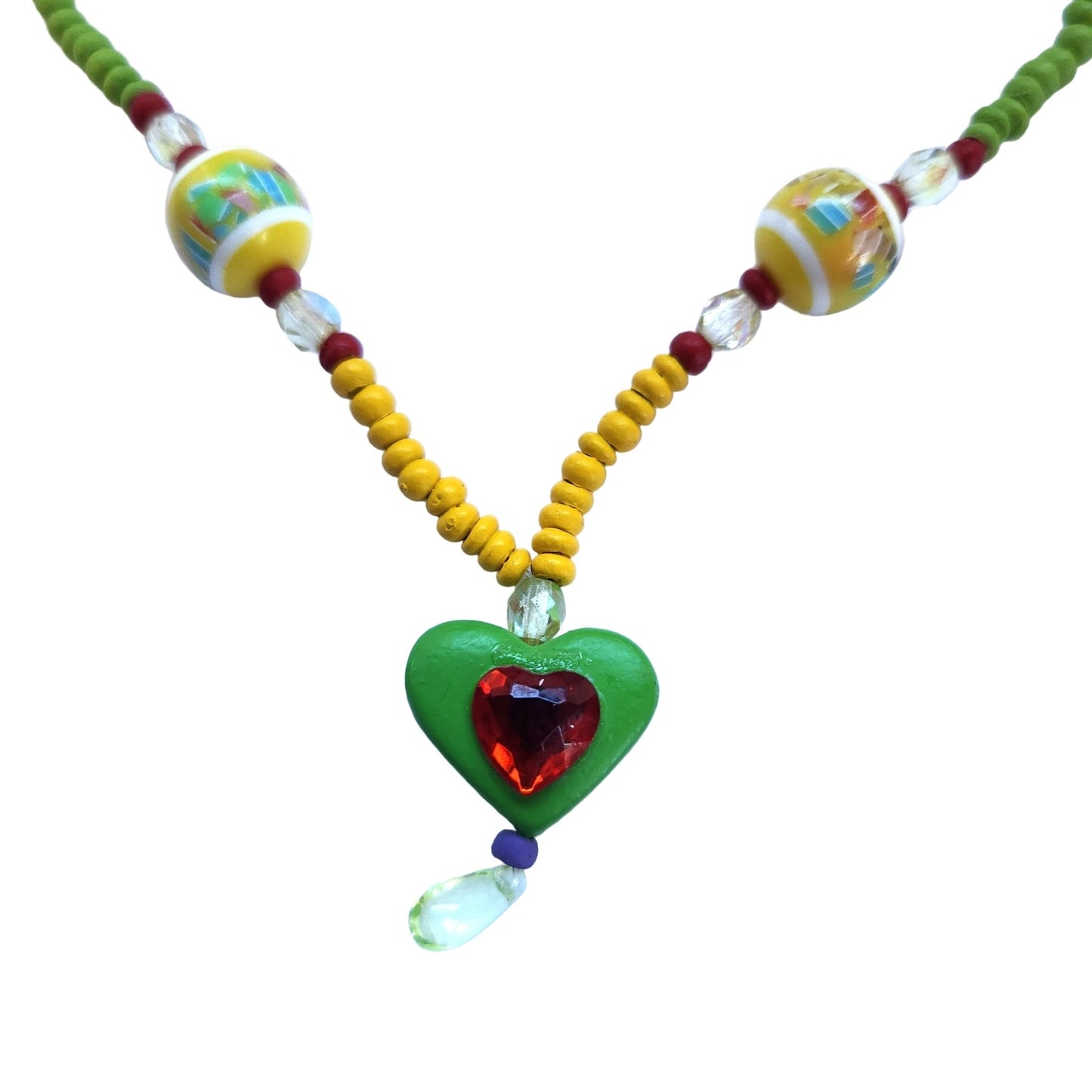 Close up of a colorful beaded necklace with a heart-shaped pendant on a white background