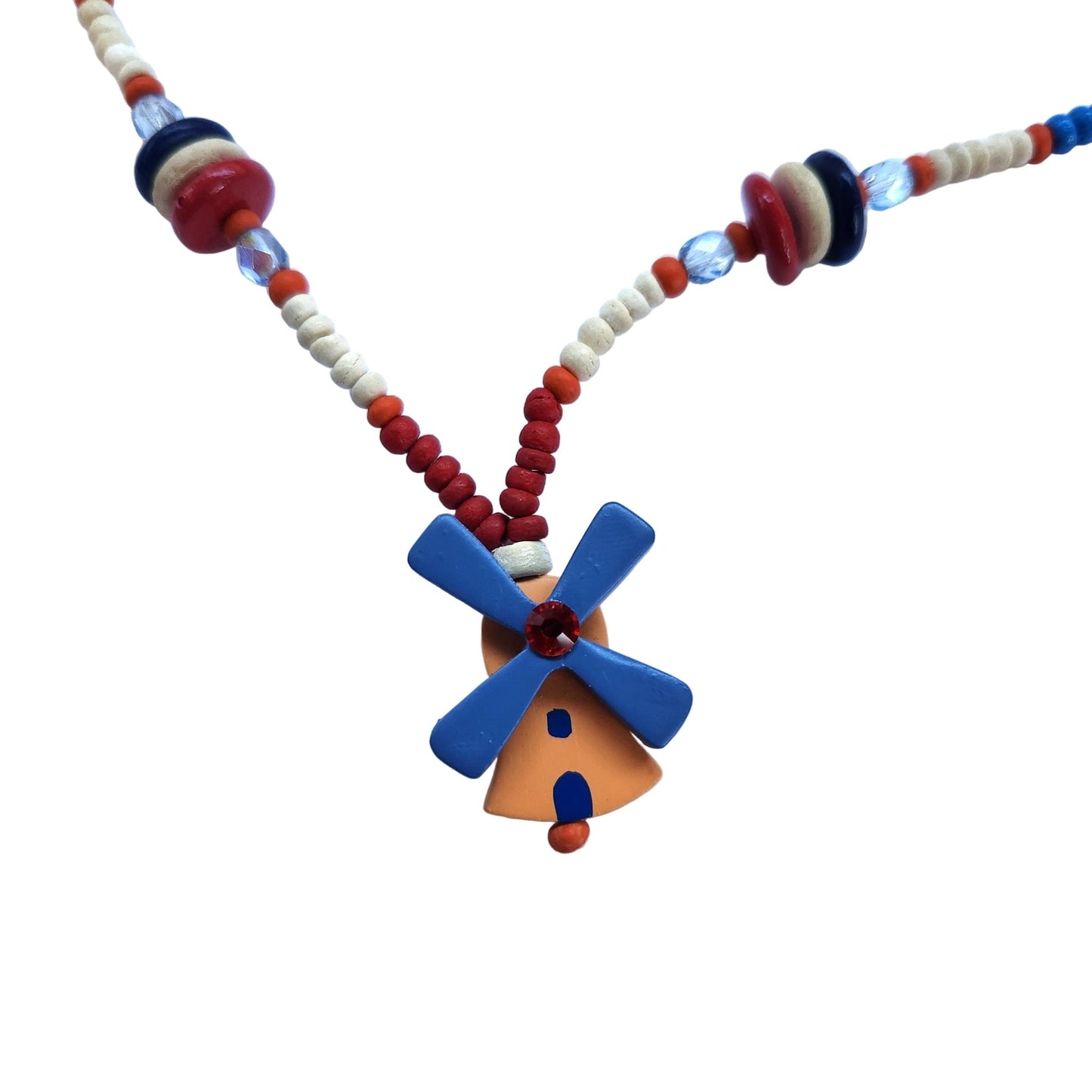 Close up of a colorful wooden beaded necklace with a windmill pendant on a white background