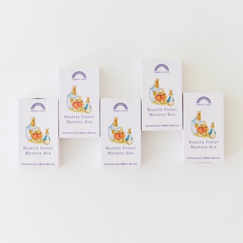 Five white boxes of Beatrix Potter Mystery Box collectible mini-minds arranged on a plain white background.
