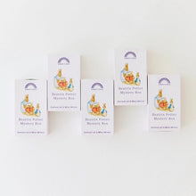 Five white boxes of Beatrix Potter Mystery Box collectible mini-minds arranged on a plain white background.