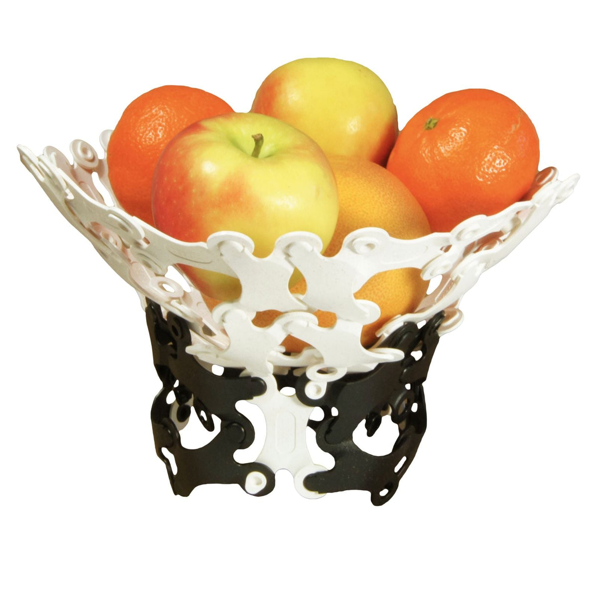Black and white Binabo chips put together in the shape of a fruit bowl, holding apples and oranges on a white background