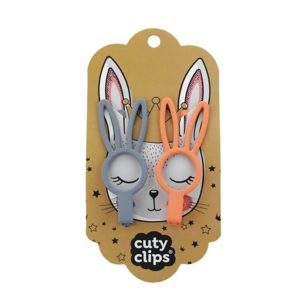 Two bunny-shaped hair clips in grey and orange on a 'cuty clips' branded card with a plain background.