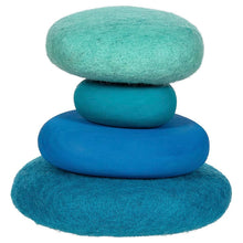 4 blue felt stones stacked on top of each other against a white background