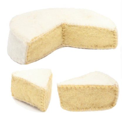 Partial wheel of felted camembert cheese and 2 wedges on a white background