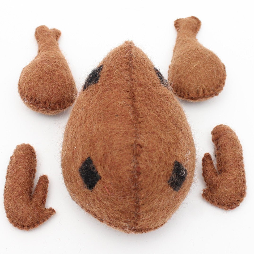 Felted cooked chicken with removeable wings and drumsticks on a white background