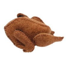 Side view of felted cooked chicken on a white background