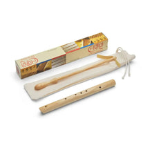 Wooden flute with packaging on a white background