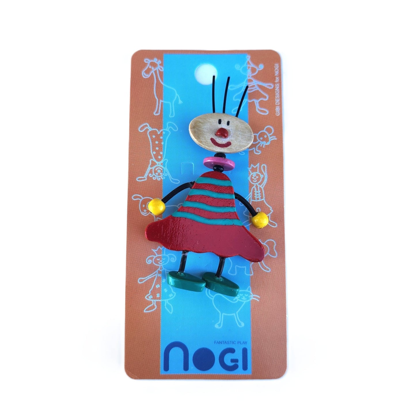 Wooden pin of a clown wearing a teal and red striped dress on Nogi branded packaging
