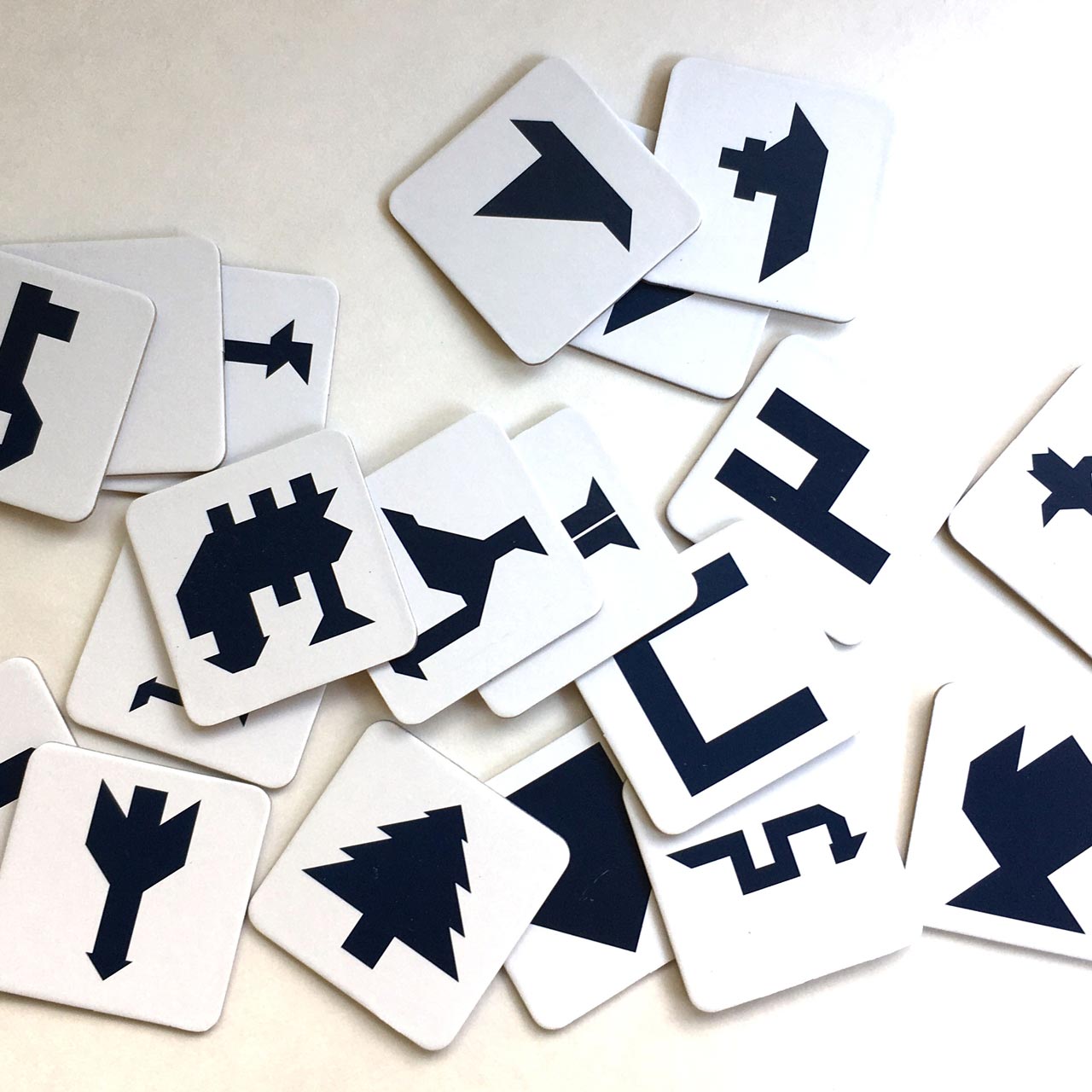 Set of white cards with black symbols on a light background