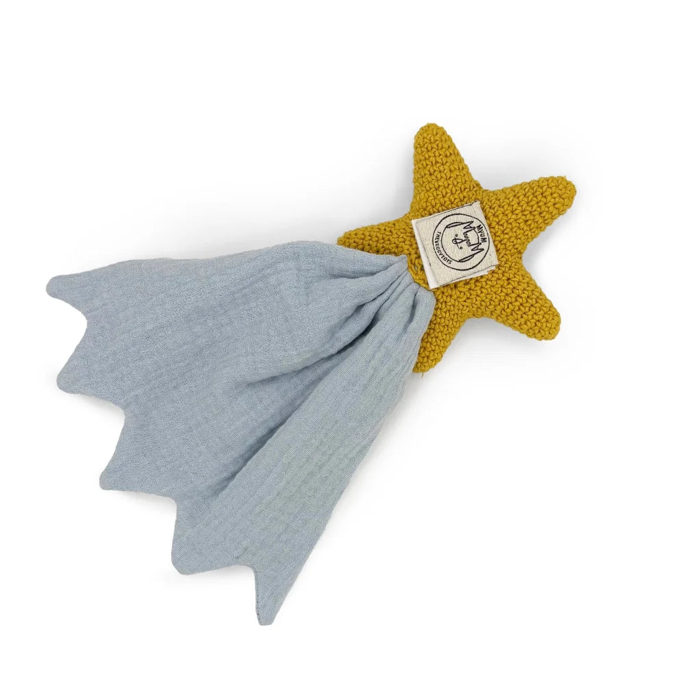 Star-shaped knitted toy with a blue blanket on a white background
