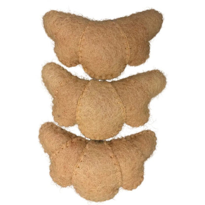 3 felted croissants arranged in a line on a white background
