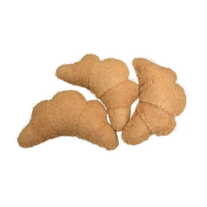 3 felted croissants on a white background