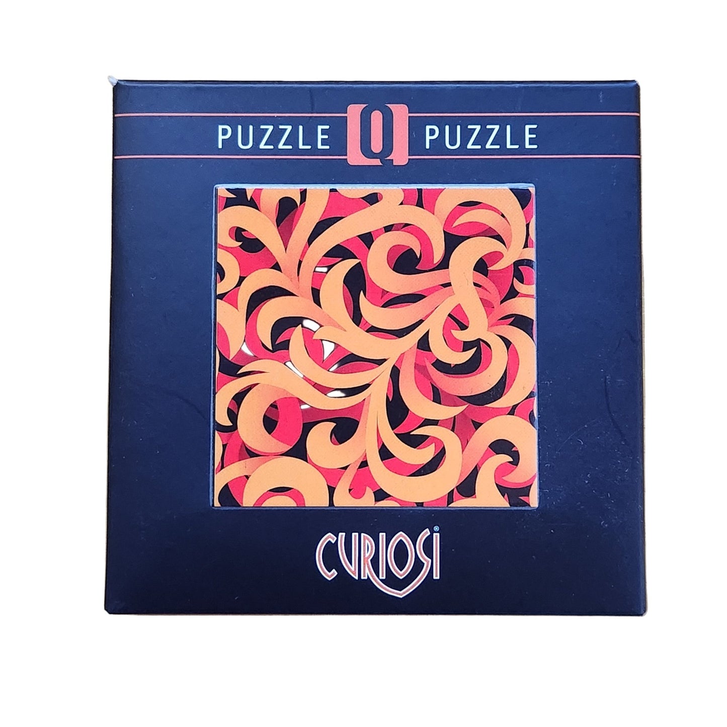 Curiosi Q puzzle packaging with abstract design on a wooden surface