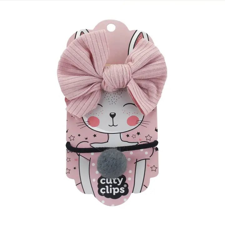 Cuty Clips pink, black, and grey hair bands with branded packaging on a white background