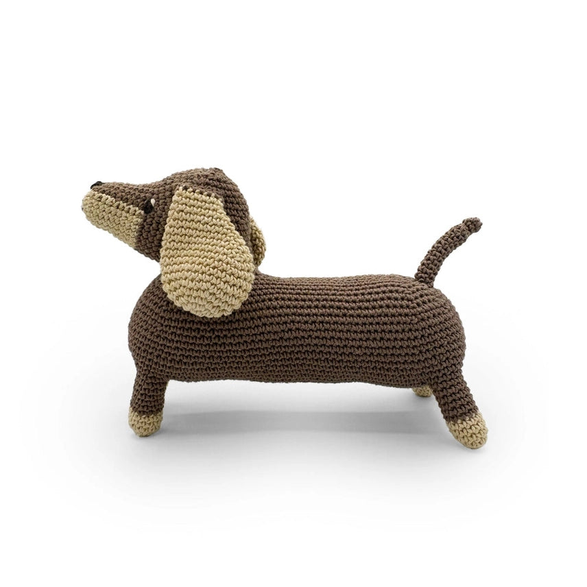 Side profile of stuffed crocheted dachshund on a white background