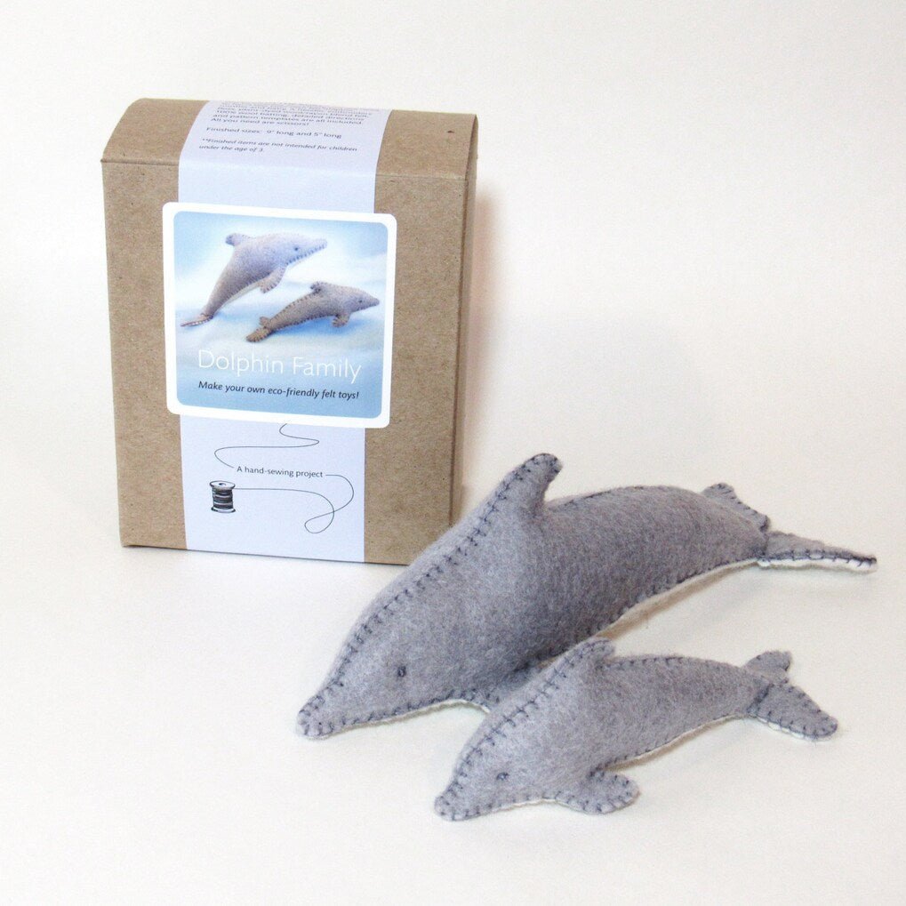 Dolphin family sewing kit with two felt dolphins on a white background