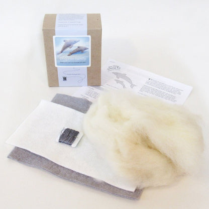 Contents of dolphin family sewing kit on a light background