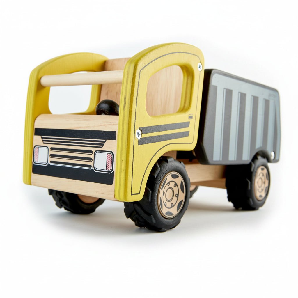 A wooden toy truck with a yellow cab, natural wood body panels, black wheels, and a gray striped cargo bed, photographed on a clean white background.