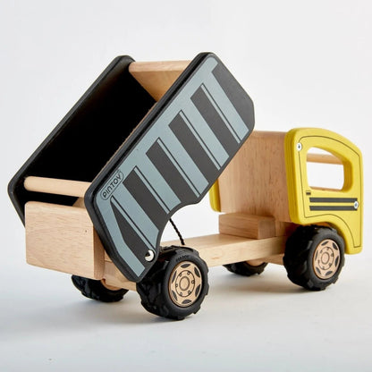A wooden toy dump truck with a natural wood body, a yellow cab, and a black and gray striped dump bed, shown on a clean white background.