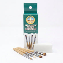 Four eco-friendly brushes and a sponge laid out in front of Natural Earth Paint branded packaging on a white background