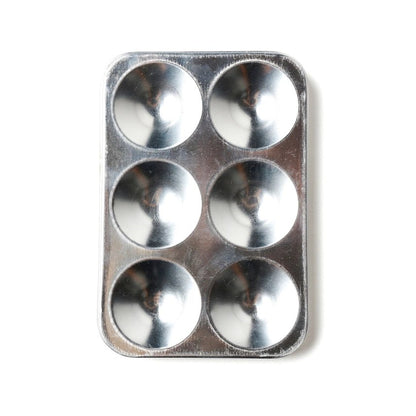 Metal paint palette with six circular compartments on a white background
