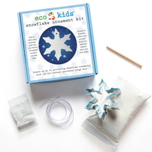 Eco-Kids ornament kit with straw, glitter, ribbon, snowflake cookie cutter on a white background