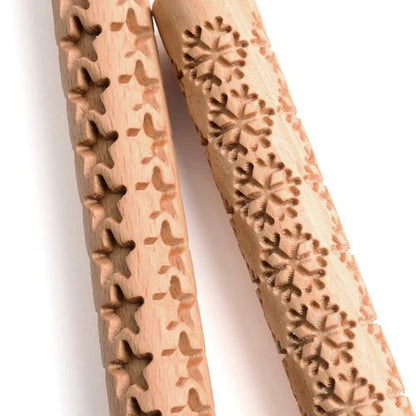 Close up view of Eco-Dough wooden rollers with star and snowflake patterns.