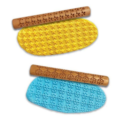 Two wooden Eco-Dough rollers, one with star patterns on yellow Eco-Dough, and one with snowflakes on blue Eco-Dough.