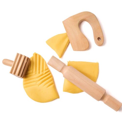 Wooden play dough tools including a rolling pin, knife, and textured roller on a white background