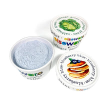 Powdered blue fingerpaint in a cardboard container next to container of green finger paint on a white background