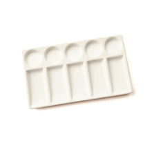 White ceramic paint palette on a white background