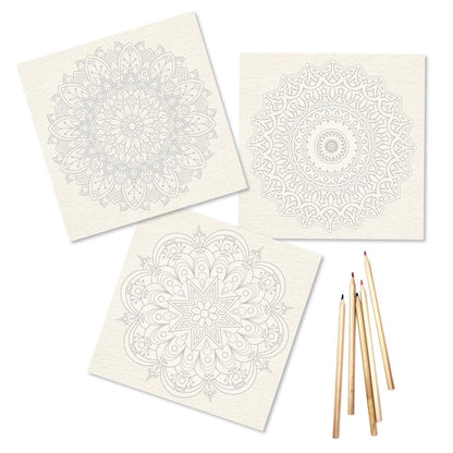 Three white cards with black mandala designs and wooden pencils on a white background