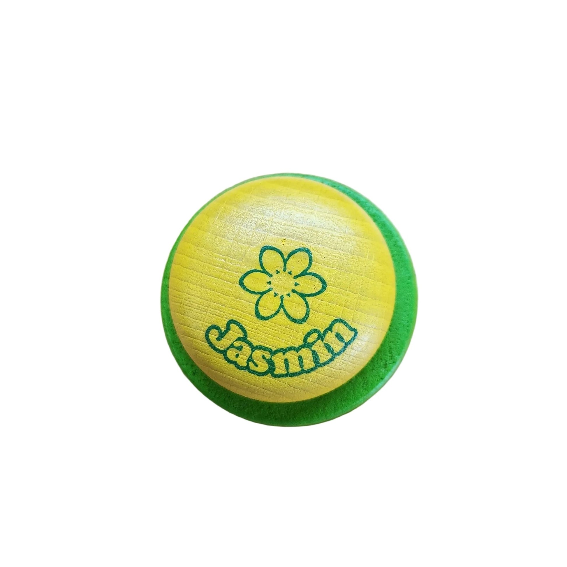 Wooden play yellow soap and green dish labeled Jasmin on a white background