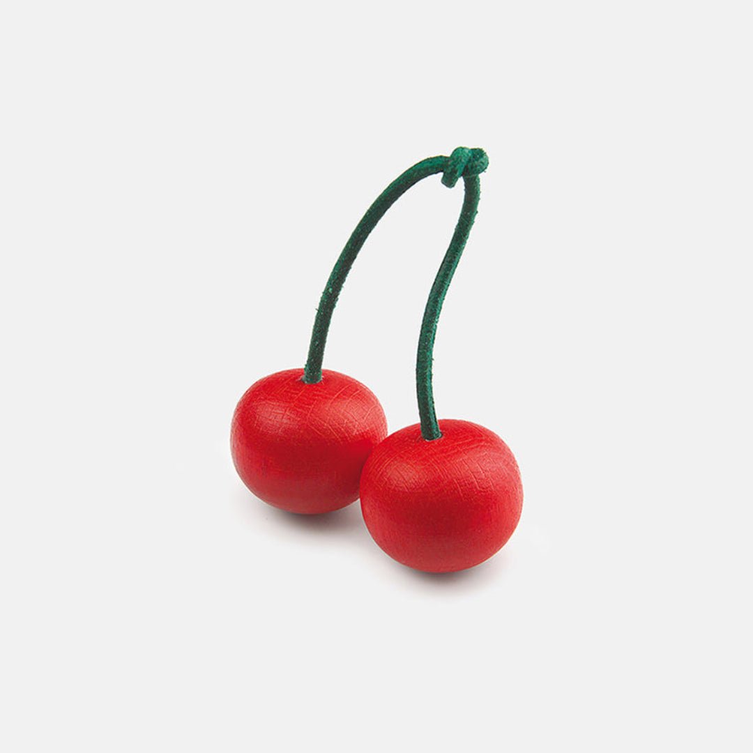 Two wooden cherries tied at the stem on a white background