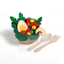 Wooden bowl of salad with spoon and fork on a white background