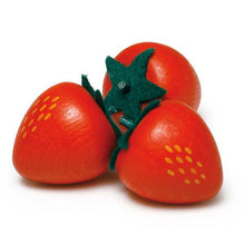 Three wooden strawberries in a pile on a white background