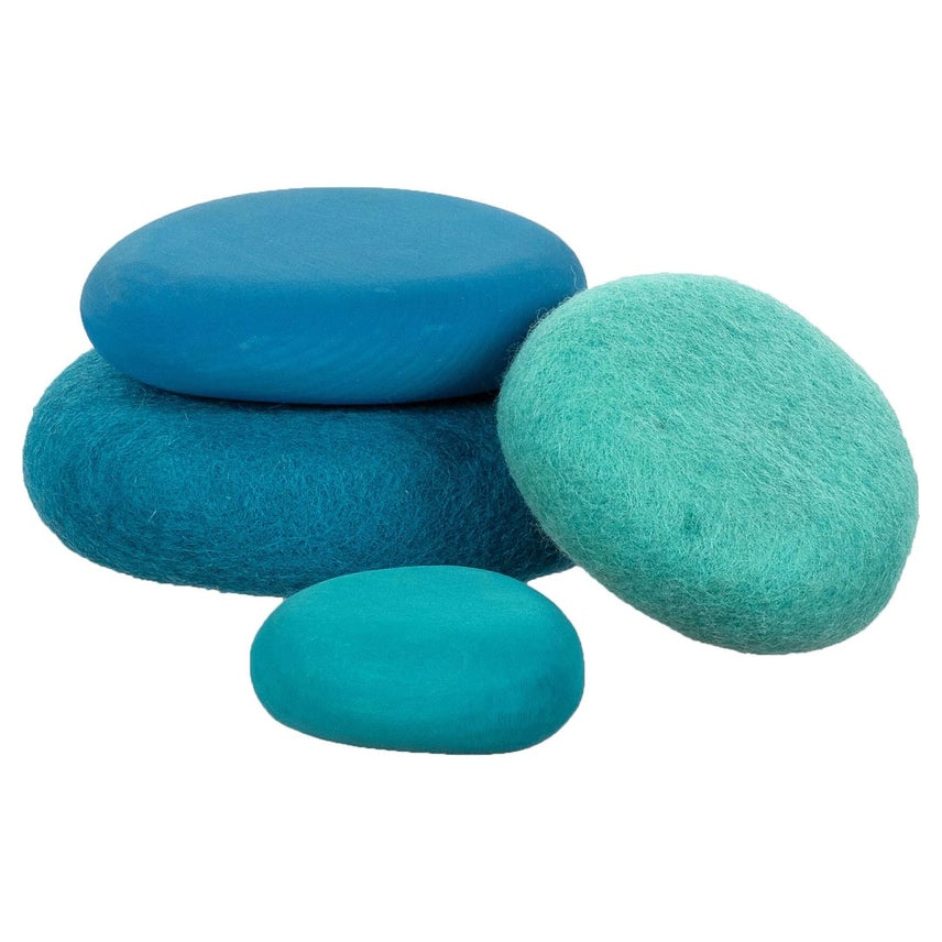 Four oval felt stones in shades of blue and teal, arranged on a plain white background.