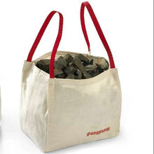 Two linen bags with red handles carrying rocks on a white background