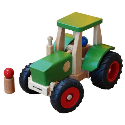 Wooden toy tractor with peg people on a white background