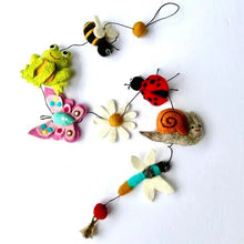 Needle felted garland featuring a bee, frog, butterfly, white daisy, ladybug, snail, and dragonfly against a white background