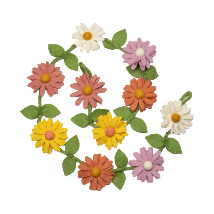 Colorful felt flower garland with white, yellow, and pink daisies on a white background