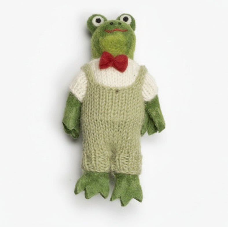 Knitted frog toy with a red bow tie on a white background