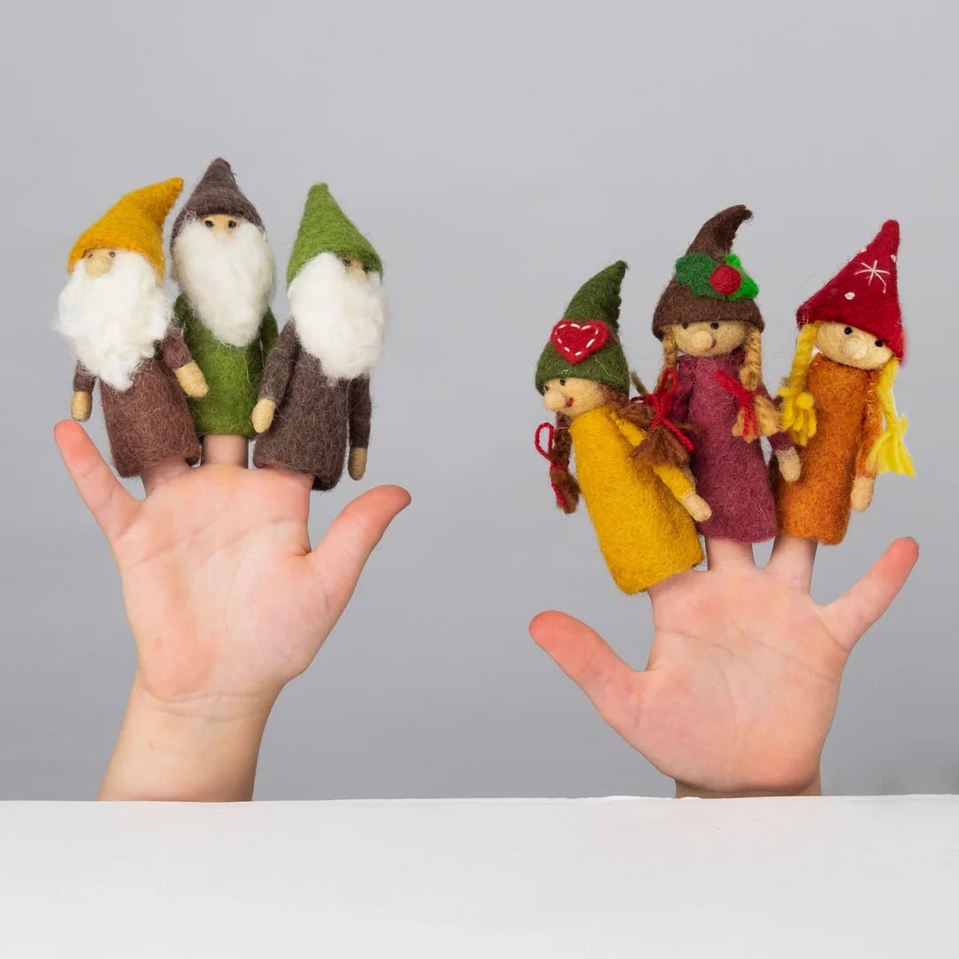6 gnome finger puppets on a person's fingers against a gray background