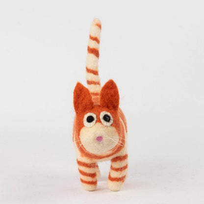 A small felted wool cat figurine with orange and cream stripes, standing against a plain white background.